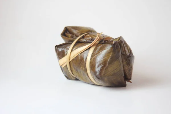 Thailand rice cakes bundle wrapped banana leaves on a white background