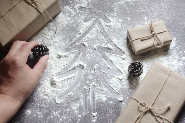 Draw a Christmas tree on the dough and presents made from recycled paper.