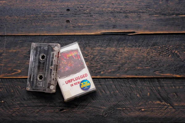 stock image Bangkok, Thailand - June,23 2021 : 90's cassette tapes of Nirvana on a black wooden floor. in usa
