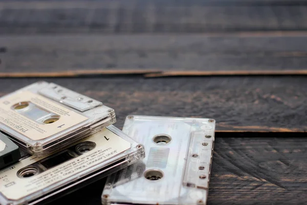 stock image Bangkok, Thailand - June,23 2021 : 90's cassette tapes of The Beatles, John Lennon and Nirvana on a black wooden floor. in USA.