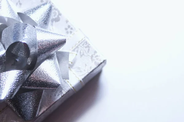 silver gift box and silver ribbon on white background