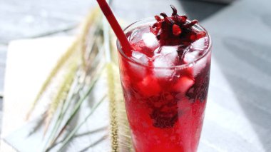 Bardakta Roselle suyu, beyaz bir masaya konur..