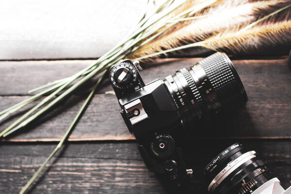 Retro film camera and negative film on a black wooden table