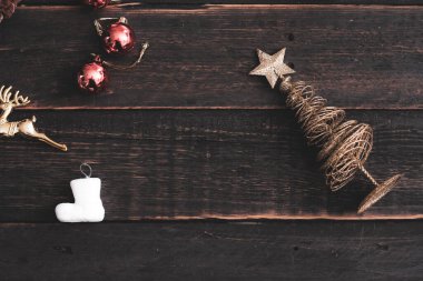 Siyah ahşap bir masaya yerleştirilmiş Noel süslerinin en üst görüntüsü.