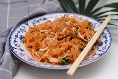 Tayland yemeği Pad Thai (ulusal yemek) Çin usulü bir kasede servis edilir. Beyaz bir masaya koy..