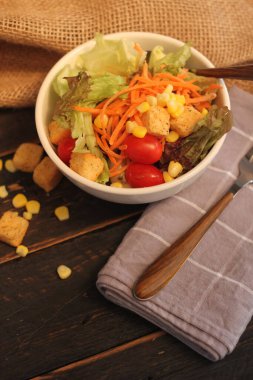 Sezar salatası ve Sezar sosu. Siyah ahşap bir masada.