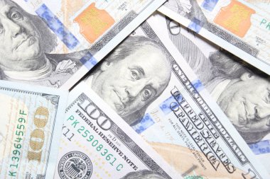 100 dollar US banknotes placed on a white background.