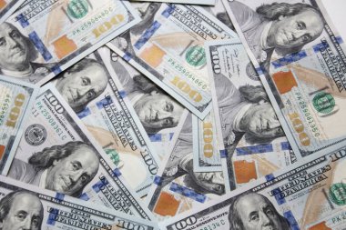 100 dollar US banknotes placed on a white background.