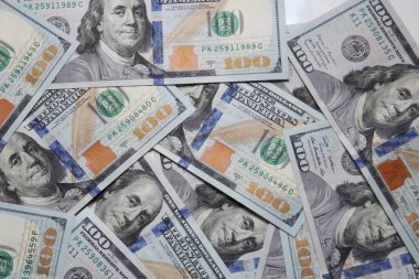 100 dollar US banknotes placed on a white background.