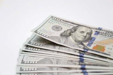 100 dollar US banknotes placed on a white background.