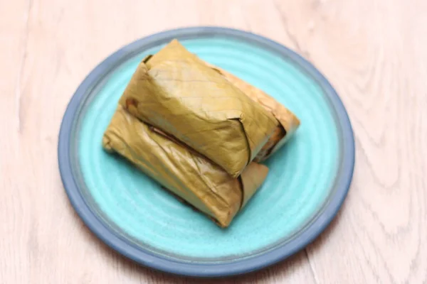 Thailand rice cakes bundle wrapped banana leaves on a white background