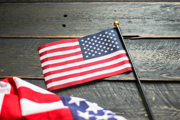 American flag on a black wooden floor illuminated from behind. in USA