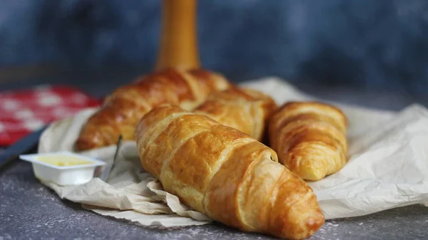 Pile Delicious Fresh Croissants Served Butter Gray Table Blue Background — Stock Photo, Image