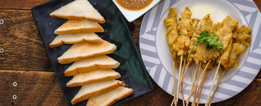 Pork satay - Fıstık soslu veya tatlı ızgara domuz eti, ekşi sos ve tost, Tayland sokak yemeği ve Tayland 'daki restoranda lezzetli yemekler.