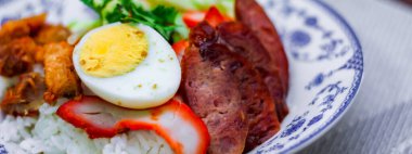 Kızarmış domuz etli pilav haşlanmış yumurta ve üstüne de tatlı sos..