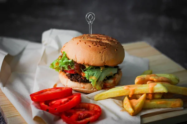 Beef Burgers Served Paper French Fries Tomatoes Popular Food — Stock Photo, Image