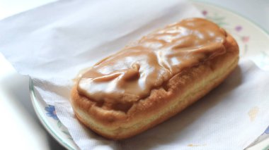 Apple Bar, Maple Bar Donut, Maple Bar Donut beyaz bir tabakta servis edilir..