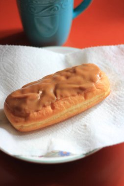 Apple Bar, Maple Bar Donut, Maple Bar Donut turuncu bir masada servis ediliyor..