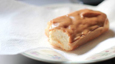 Apple Bar, Maple Bar Donut, Maple Bar Donut beyaz bir tabakta ikiye bölünmüş..