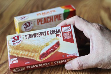 Seattle, ABD - Nisan 07 2022: JJ 'in fırınının şeftalili turtası, ahşap bir masada çilekli ve kremalı turta, aperatif olarak turta. Amerika 'da popüler.