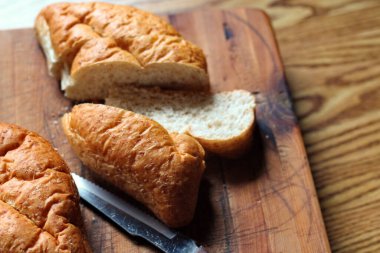 Ahşap bir masaya yerleştirilmiş fırınlanmış ekmek. Düz fotograf.
