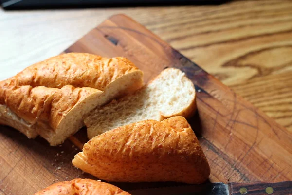 Ahşap bir masaya yerleştirilmiş fırınlanmış ekmek. Düz fotograf.