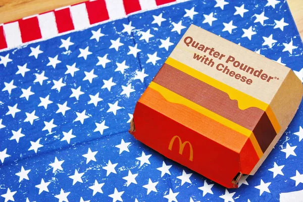WASHINGTON, USA - JULY 02 2022 : McDonald's Burgers, Quarter Powder and Cheese on American Flag Cloth, McDonald's Burgers loved in America and around the world.