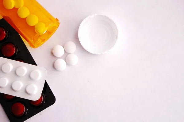 Pills, pill packs and pill bottles Placed on a white background, top view, flat-lay.