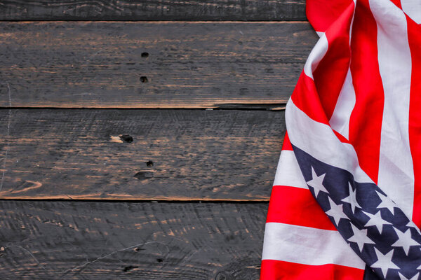 american flag placed on a black wooden table On American Independence Day.