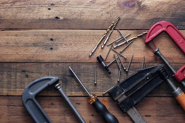 Collection of woodworking tools on a wooden background.