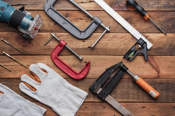 Collection of woodworking tools on a wooden background.