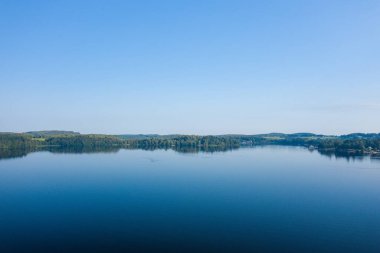 This landscape photo was taken in Europe, France, Burgundy, Nievre, Morvan, in summer. We see the panoramic view of Lac des Settons, under the Sun. clipart