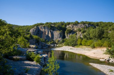 Bu manzara fotoğrafı Avrupa, Fransa, Ardeche, yaz aylarında çekildi. Güneşin altındaki yeşil bitki örtüsünde Ardeche Geçidi 'ni görebiliriz..