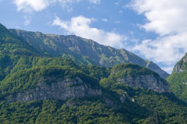 Bu manzara fotoğrafı Avrupa 'da, Fransa' da, Isere 'de, Alpler' de, yazın çekildi. Massif des Bauges 'ın üstündeki beyaz bulutları, güneşin altındaki.