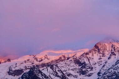 Bu manzara fotoğrafı Avrupa 'da, Fransa' da, Alpler 'de, yazın Chamonix' e doğru çekildi. Mont Blanc 'ı gün batımında pembe bulutlarla çevrili görüyoruz..