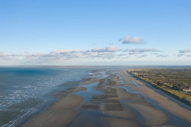 This landscape photo was taken in Europe, France, Normandy, towards Carentan, in the spring. We see the long beach of Utah Beach, under the Sun. clipart