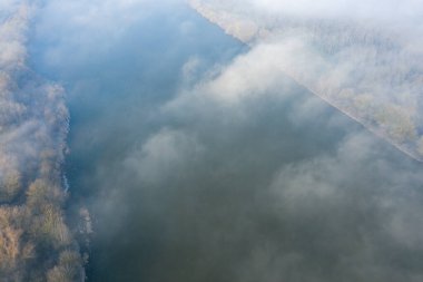 This landscape photo was taken in Europe, in France, in the Center region, in the Loiret, near Orleans, in Winter. We can see the Loire in the mist, under the Sun.