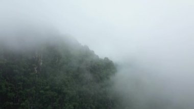 Asya 'daki yeşil dağların ve tropikal ormanların etrafındaki bulutlar, Laos, Vientiane' e doğru, Vang Vieng 'e doğru, bulutlu bir günde.