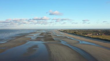 Bir traktör yazın güneşli bir günde Fransa 'nın Avrupa kırsalında çorak bir tarlayı sürüyor..