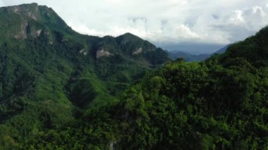 Karst peaks and mountains populated by green forests in Asia, Laos, towards Luang Prabang in summer on a sunny day.