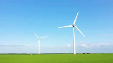 Norman wind turbines in the middle of flax and barley fields, in Europe, France, Normandy, Seine Maritime, towards Fecamp, in summer, on a sunny day.