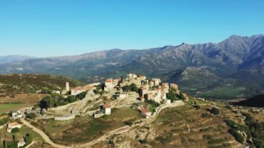 The city of Sant'Antonino in the middle of the arid and green mountains, in Europe, in France, in Corsica, by the Mediterranean Sea, in summer, on a sunny day.