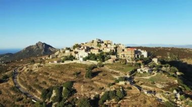 The city of Sant'Antonino in the middle of the arid and green mountains, in Europe, in France, in Corsica, by the Mediterranean Sea, in summer, on a sunny day.