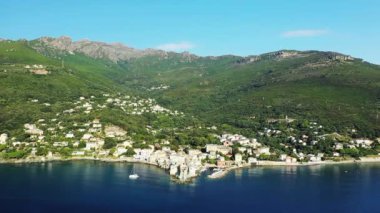 The city of Erbalunga in the middle of the arid and green mountains, in Europe, in France, in Corsica, towards Bastia, by the Mediterranean Sea, in summer, on a sunny day.
