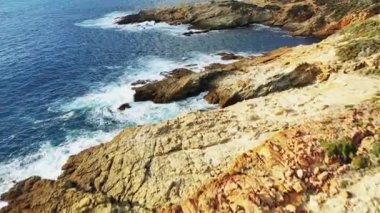 Fango Delta pebble beach among mountains and green countryside , Europe, France, Corsica, Mediterranean Sea coast, in summer, on a sunny day.