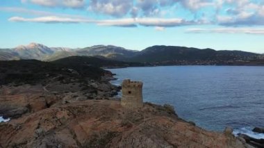 The arid and rocky countryside around Cargese and its Genoese tower, in Europe, in France, in Corsica, towards Ajaccio, by the Mediterranean Sea, in summer, on a sunny day.