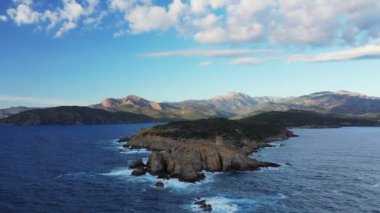 The arid and rocky countryside around Cargese and its Genoese tower, in Europe, in France, in Corsica, towards Ajaccio, by the Mediterranean Sea, in summer, on a sunny day.
