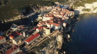 The town of Bonifacio above the chalk cliffs in the green countryside , Europe, France, Corsica, towards Ajaccio, by the Mediterranean Sea, in summer, on a sunny day.