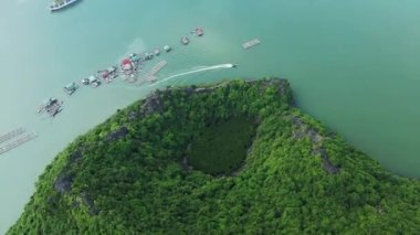 The floating villages amid green karst cliffs in Ha Long Bay , Asia, Northern Vietnam towards Hai Phong, Lanh Ha in summer on a sunny day.