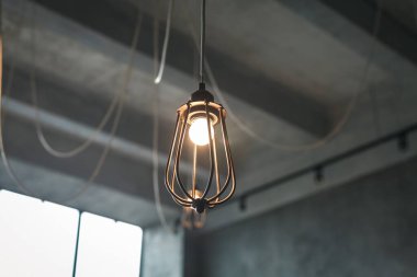 Glowing light bulb in a dim room 